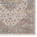 Detailed view of rug corner with floral medallion pattern and intricate blue and beige border