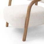 Close-up of looped textile surface highlighting plush ivory woven yarn on chair seat
