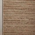 Top-down view highlighting the Merrick rug's finished light beige edge binding
