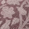 Close-up of pillow fabric texture with botanical weave pattern in two plum tones