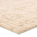 Close-up angled view showing dense wool texture and pile height of striped caramel and cream rug