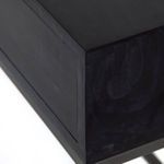 Leather drawer pull detail showing supple tan loop against black wood