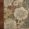 Corner of rug flat on hardwood floor showing detailed floral pattern and edge stitching