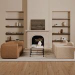 Living room scene with Alora sofa paired with patterned armchairs by a fireplace