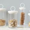 Four Bianca canisters shown in a row, each filled with oats, cereal, cookies, and crackers