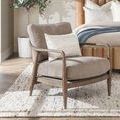 Lennon Accent Chair styled in bedroom with modern wooden bed, cream pillow, and natural light