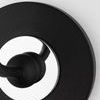 Detailed close-up of black metal circular base with polished chrome accent on Merri sconce