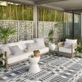 Rainier Ivory / Denim Rug styled in outdoor seating area under covered patio