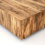 Detailed close-up of wood spalting and subtle color shifts on table surface edge