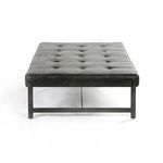 Detail of flat iron bench leg with protective floor feet and matte black coating
