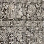 Macro view of rug fibers showing detailed weave structure with hints of white and brown threads