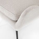 Close-up of chair armrest and seat cushion edge highlighting fabric weave and stitching