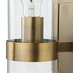 Extreme close-up of sconce’s brass ring and socket inside clear glass cylinder