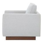 Side profile highlighting straight armrest and thick back cushion