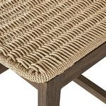 Close-up of tightly woven seat corner detailing on stained teak frame
