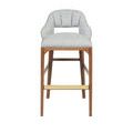 Front view of Inga Stool focusing on seat shape and brass accent on footrest
