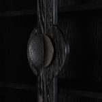 Detailed view of rounded hammered iron hardware on cabinet doors