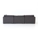 Side close-up of sectional with focus on armrest fabric and cushion layering