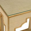Close-up of cream raffia texture topped with clear glass and gold trim on console corner