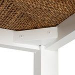 Underside close-up of stool seat corner with screws attaching seat to white frame