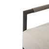 Close-up of rounded armrest detail wrapped with shale-colored rope above light textured cushion