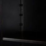 Close-up of black steel interior with adjustable shelf supports inside the hutch.