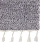 Detailed corner view highlighting gray flecked weave and white tassels