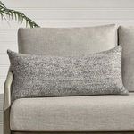 Stella Throw Pillow styled on light gray outdoor sofa with vertical white plank wall background