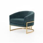 Slightly angled view of Corbin Chair emphasizing seat and arm curves alongside brass frame