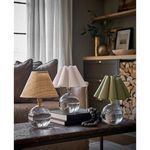 Three table lamps on rustic wooden table with white scalloped shade centered and green scalloped shade on right