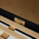 Wooden slat support detail inside Quincy Bed frame featuring natural light wood tones