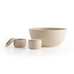 Two salt jars and a large ceramic bowl arranged on white surface