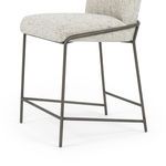 Lower seated angle showing iron tube footrest and base structure in brushed slate finish