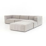 Reversed angle of sectional with ottoman, featuring the continuous channel tufting across all pieces
