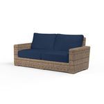 Havana Loveseat with rich Aged Tobacco all-weather wicker frame and deep navy blue cushions, designed for outdoor comfort
