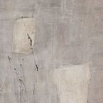 Detailed close-up of textured beige and cream paint strokes with some fine black paint splatters