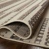 Rainier Ivory Taupe rug partially folded to show pile thickness, texture, and tightly bound edges.