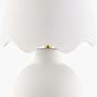 Stella Dimiuta white accent table lamp with textured round ceramic base and white scalloped fabric shade topped with brass...