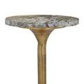 Alternate side view showing patina and texture on gold metal base supporting marble top
