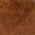 Close-up detail of ottoman distressed Italian leather showing rich chestnut color and texture
