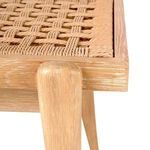 Close-up of corner detail where seagrass seat meets rounded oak leg