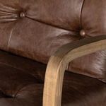 Side view of chair showing seat height adjustment lever beneath cushioned seat.
