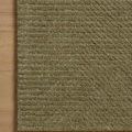 Kai Olive Rug corner positioned on light wood floor highlighting color and textured rib pattern