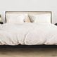 Styled bedroom scene with Haven Woven Bed dressed in white linens flanked by matching nightstands
