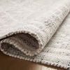 Folded Rivers Lagoon rug showing reversible flatweave side