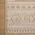 Close-up top view of rug border on wooden floor highlighting textured weave