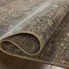 Close-up of rug edge softly folded to reveal thickness and wool-like texture