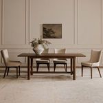 Group of four Posta dining chairs spaced evenly around wood dining table against panelled wall