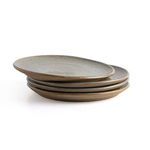 Stack of four speckled clay plates viewed from low side angle showing thickness and layered edges