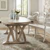 Dining table from diagonal side angle paired with white distressed bench and ceramic vases on top